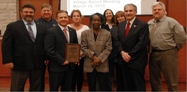 Romeoville accepting award for RAEC